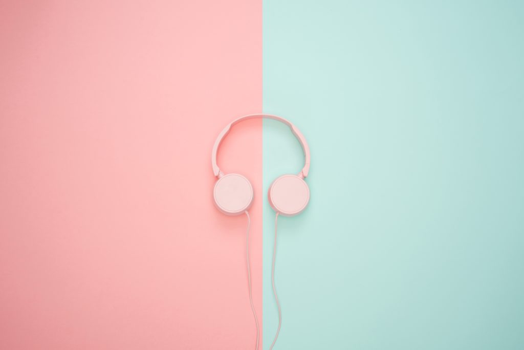 pink headphones on pink and teal background