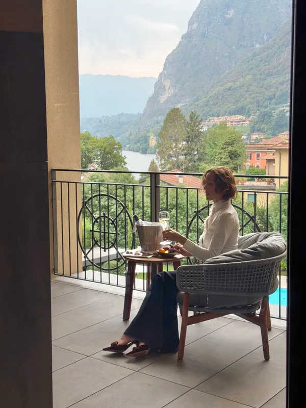 A glass of wine on a private balcony overlooking Lake Como