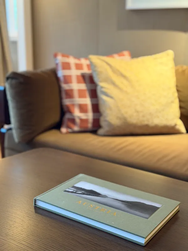 An Austria coffee-table book beside a softly upholstered sofa